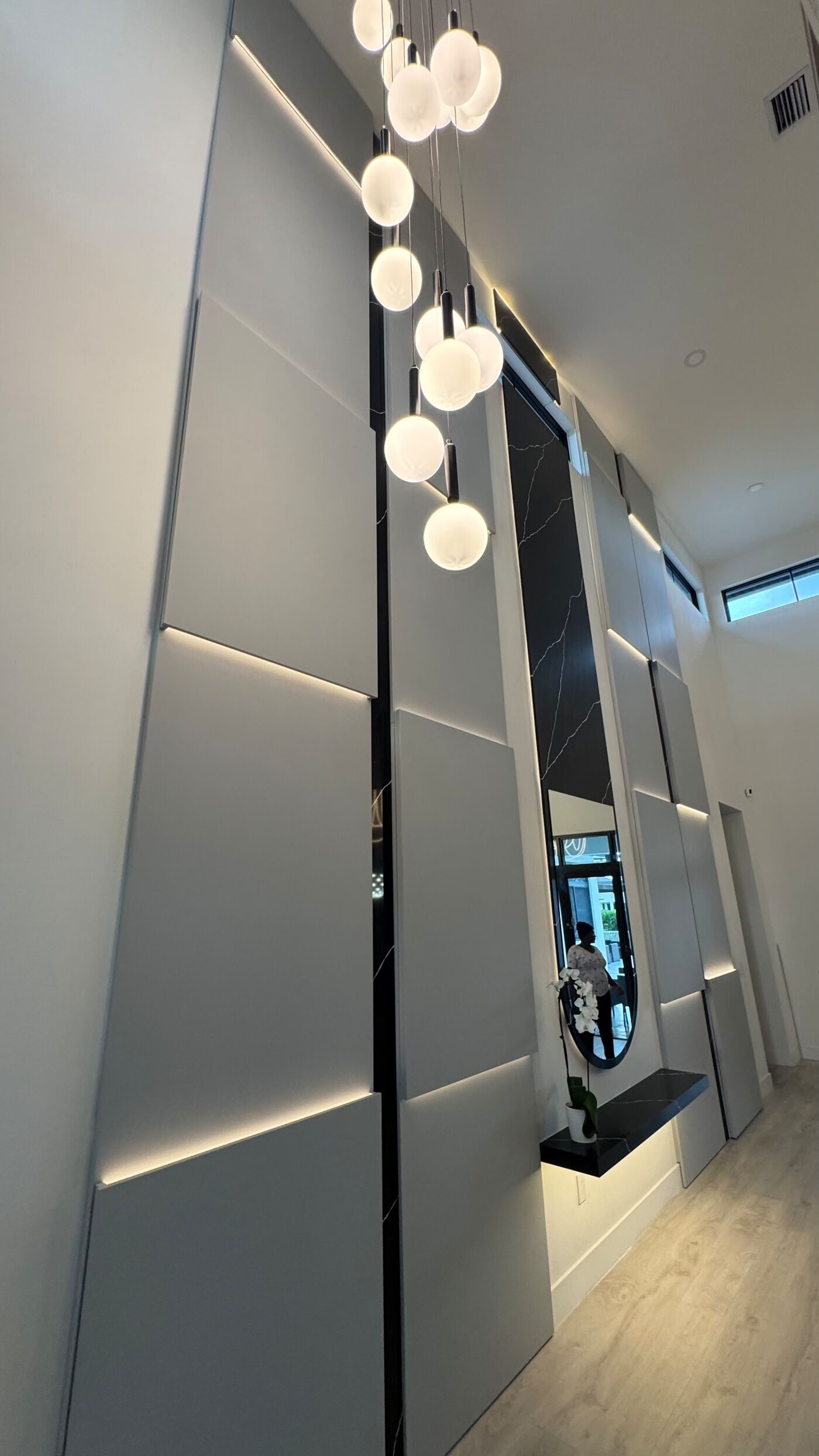 Detail: light grey panels crossed by lines of LED light.